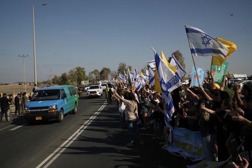 People react as a convoy carrying the hostages released from the Gaza Strip arrives at a military base near Reim, southern Israel, on Monday, Oct. 13, 2025. (AP Photo/Leo Correa)
Israel Palestinians G ...