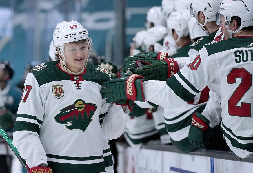 FILE - Minnesota Wild left wing Kirill Kaprizov (97) is congratulated by teammates after scoring a goal against the San Jose Sharks during the third period of an NHL hockey game in San Jose, Calif., i ...