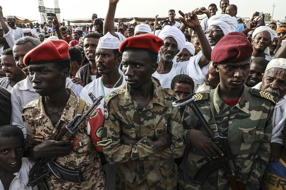 Members of the military stand as Gen. Mohammed Hamdan Dagalo, the deputy head of the military council, speaks during a military-backed tribe&#039;s rally, in the Nile River State, Sudan, Saturday, , o ...