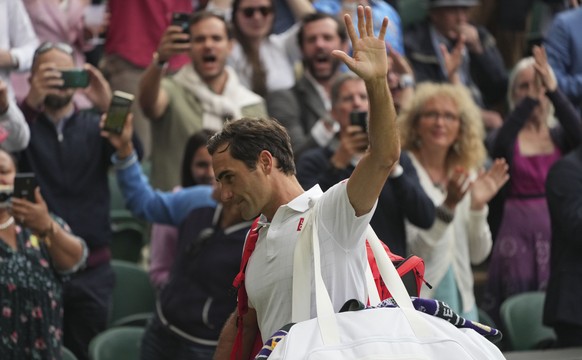 Switzerland&#039;s Roger Federer leaves the court after being defeated by Poland&#039;s Hubert Hurkacz during the men&#039;s singles quarterfinals match on day nine of the Wimbledon Tennis Championshi ...