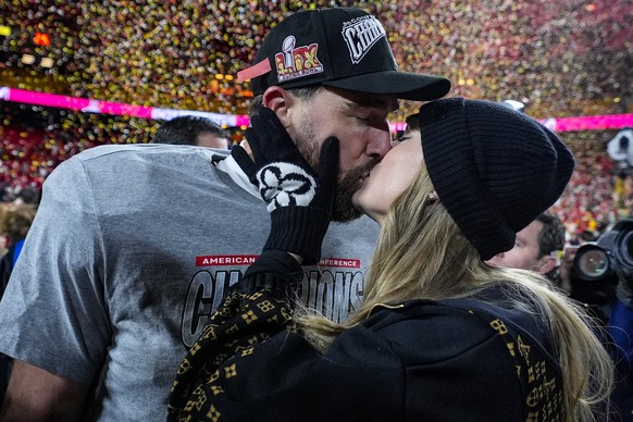 FILE - Kansas City Chiefs tight end Travis Kelce and Taylor Swift kiss after the AFC Championship NFL football game against the Buffalo Bills, Jan. 26, 2025, in Kansas City, Mo. (AP Photo/Ashley Landi ...