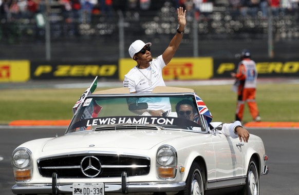 Mercedes driver Lewis Hamilton, of Britain, waves to the crowd from a classic Mercedes car before the Formula One Mexico Grand Prix auto race at the Hermanos Rodriguez racetrack in Mexico City, Sunday ...