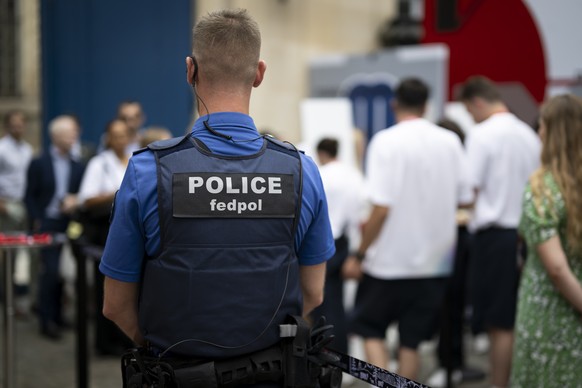 A policeman of the Federal Police Fedpol supervises the entrance of guests prior to the opening ceremony of the Maison Suisse in the Swiss Embassy in Paris, prior to the 2024 Paris Summer Olympics in  ...