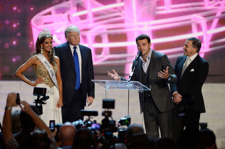 In this Sunday, June 16, 2013, file photo, from left, Miss Connecticut USA Erin Brady and Donald Trump look on as Russian singer Emin Agalarov speaks onstage with his father Aras Agalarov during a new ...