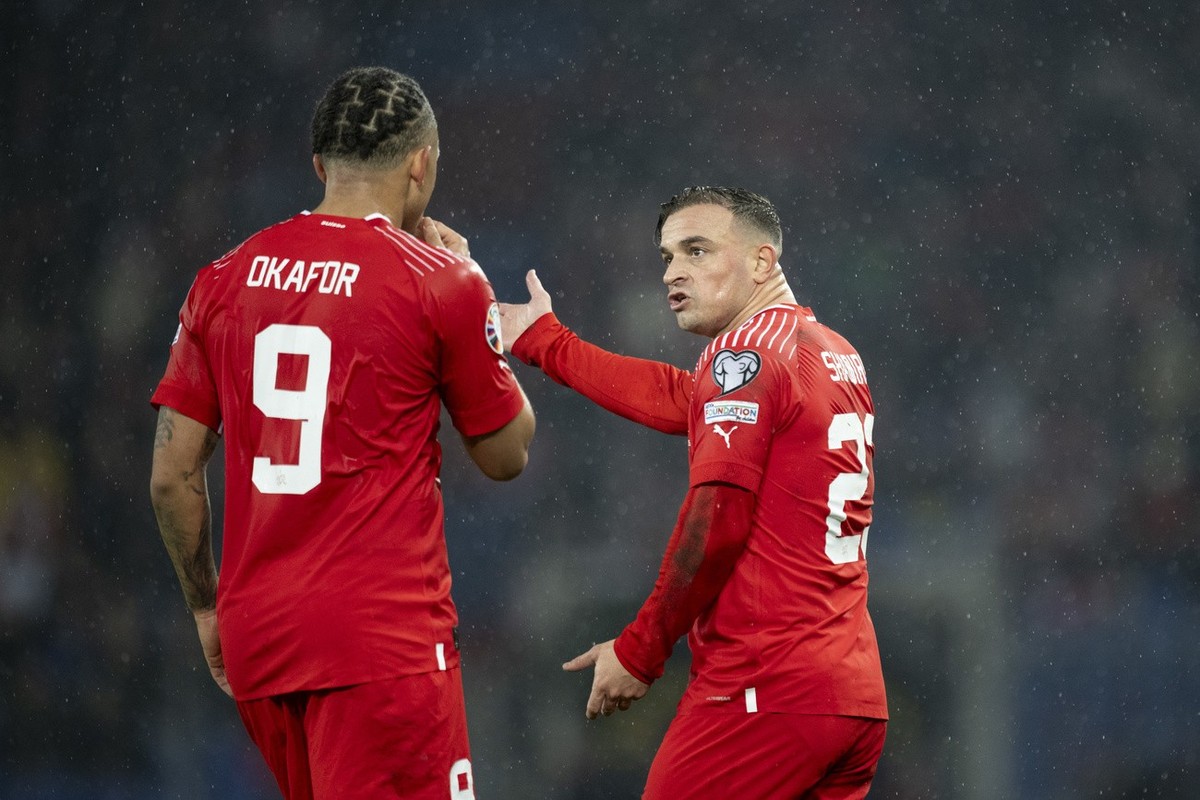 Switzerland's Xherdan Shaqiri, right, speaks with Noah Okafor during the UEFA Euro 2024 qualifying group I soccer match between Switzerlandat and Kosovo at the St. Jakob-Park stadium in Basel, Sw ...