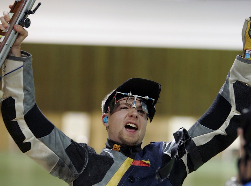 USA's Matthew Emmons realizes he just won the men's 50m rifle prone finals at the 2004 Summer Olympic Games in Athens, Friday, Aug. 20, 2004. Emmons won the gold, Germany's Christian Lusch won the sil ...