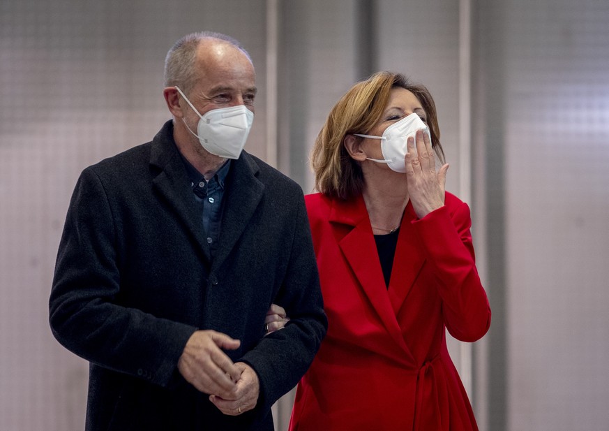 Social democratic prime minister of Rhineland-Palatinate Malu Dreyer blows a kiss next to her husband Klaus Jensen after hearing first results of the federal state elections in Mainz, Germany, Sunday, ...