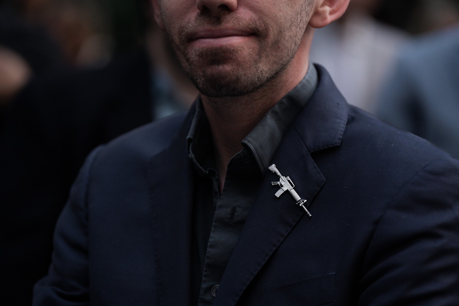 epaselect epa12372221 A mourner wears a pin in the shape of an assault rifle during a vigil for US conservative activist and Turning Point USA founder Charley Kirk in New York City, New York, USA, 12  ...