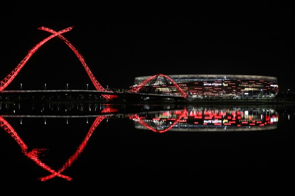 epa07710988 Optus Stadium is lit up in red lights to celebrate the upcoming games featuring Manchester United Football Club in Perth, Thursday, July 11, 2019. The English Premier League club is in Aus ...