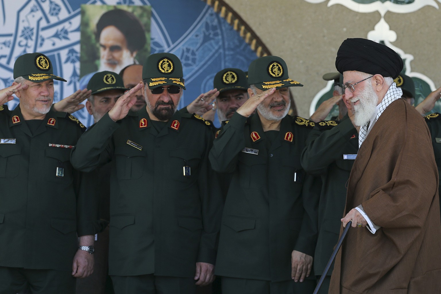 In this picture released by an official website of the office of the Iranian supreme leader on Wednesday, May 20, 2015, Supreme Leader Ayatollah Ali Khamenei, right, arrives at a graduation ceremony o ...