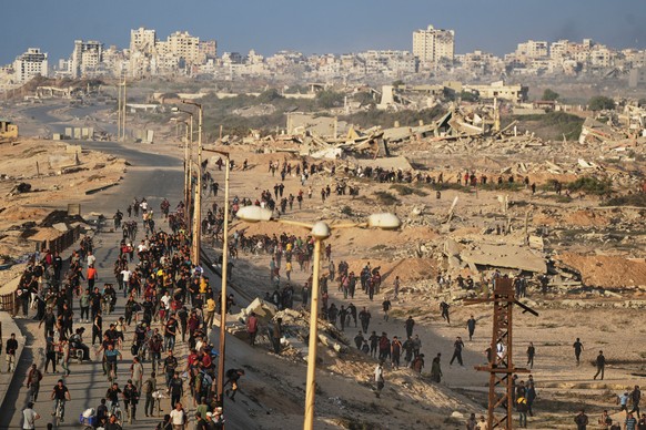 Israeli tanks are positioned on the coastal road leading to Gaza City as displaced Palestinians gather near Wadi Gaza in the central Gaza Strip, Thursday, Oct. 9, 2025. (AP Photo/Abdel Kareem Hana)
Is ...