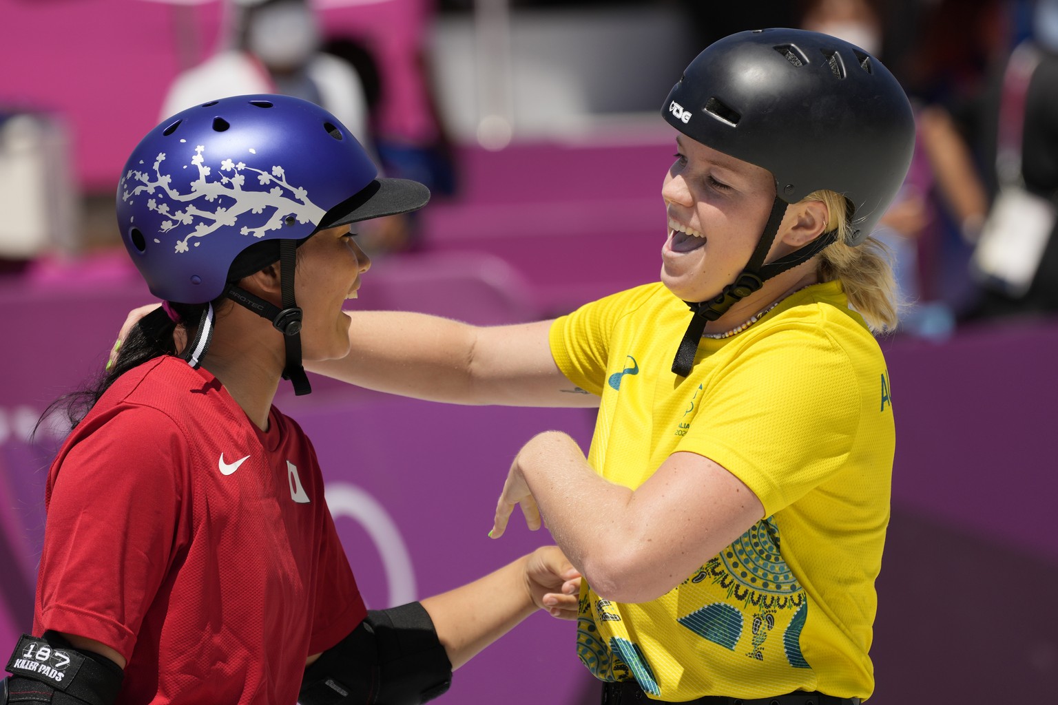 Poppy Starr Olsen of Australia celebrates her run with Sakura Yosozumi of Japan during women&#039;s park skateboarding finals at the 2020 Summer Olympics, Wednesday, Aug. 4, 2021, in Tokyo, Japan. (AP ...