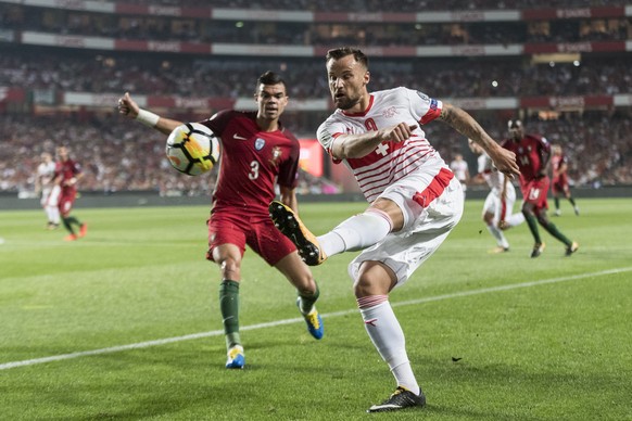 Portugal&#039;s Pepe, left, watches Switzerland&#039;s Haris Seferovic, right, kick the ball during the 2018 Fifa World Cup Russia group B qualification soccer match between Portugal and Switzerland a ...