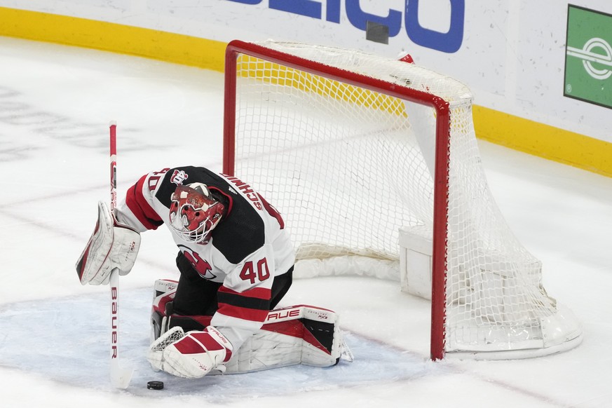 New Jersey Devils goaltender Akira Schmid (40) stops a shot during the second period of the team&#039;s NHL hockey game against the Florida Panthers, Saturday, March 18, 2023, in Sunrise, Fla. (AP Pho ...