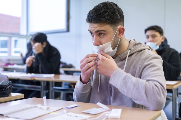 A pupil takes a Corona antigen rapid test before the start of lessons at the Katharina Henoth Comprehensive School in Cologne, Germany, Monday, April 19, 2021. After a week of lessons at home, many ch ...