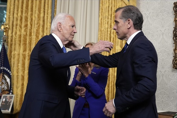 epa11752647 (FILE) - US President Joe Biden (L) hugs his son Hunter Biden after addressing the nation from the Oval Office of the White House in Washington, DC, USA, 24 July 2024. On 01 December 2024, ...