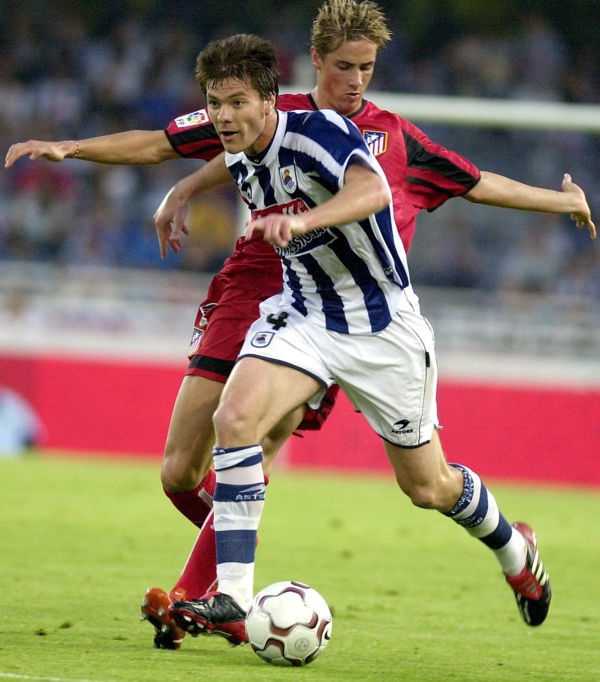 Real Sociedad's midfielder Xabi Alonso (in front) fights for the ball with Athletico Madrid Fernando Torres, during their last Spanish First Division soccer match played at Anoeta stadium in San  ...