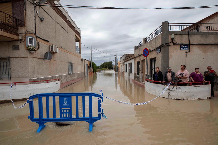 epa07842233 People wait on a street of the flooded area of Torre Alta, Molina de Segura, Murcia, southern Spain 14 September 2019. A total of six people have died due to the &#039;gota fria&#039; (col ...