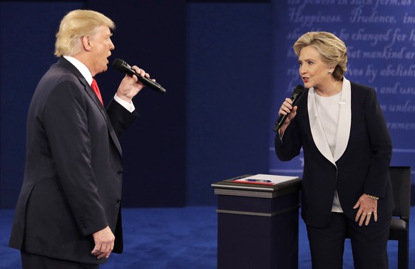 FILE - Republican presidential nominee Donald Trump, left, and Democratic presidential nominee Hillary Clinton speak during the second presidential debate in St. Louis, Oct. 9, 2016. (AP Photo/John Lo ...