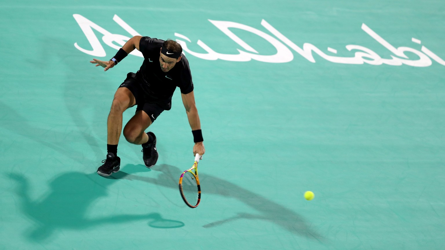 epa09647225 Rafael Nadal of Spain in action against Andy Murray of Britain during their semi final match at the Mubadala World Tennis Championship at the International Tennis Centre, Zayed Sports City ...