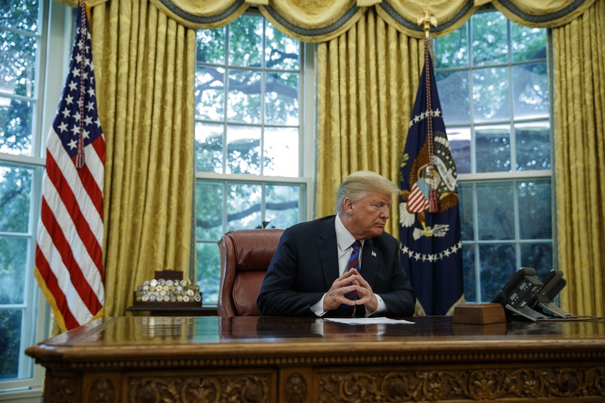 President Donald Trump talks on the phone with Mexican President Enrique Pena Nieto, in the Oval Office of the White House, Monday, Aug. 27, 2018, in Washington. Trump is announcing a trade &quot;unde ...