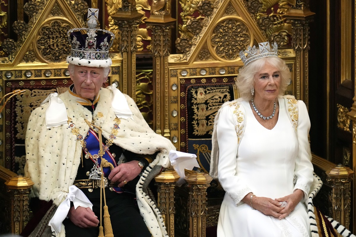 King Charles III looks up as he waits to read the King's Speech, as Queen Camilla sits beside him during the State Opening of Parliament in the House of Lords, London, Wednesday, July 17, 2024. K ...