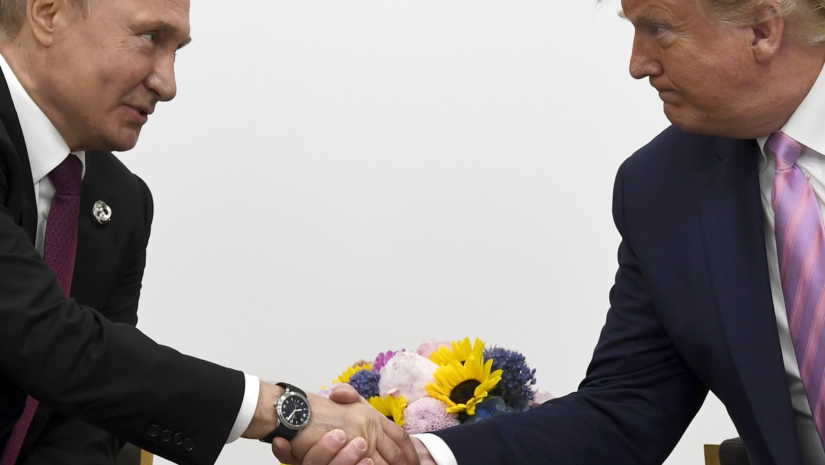 FILE - In this file photo taken on Friday, June 28, 2019, President Donald Trump, right, shakes hands with Russian President Vladimir Putin during a bilateral meeting on the sidelines of the G-20 summ ...