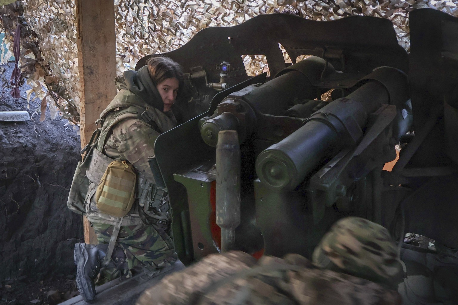 In this photo provided by Ukraine&#039;s 65th Mechanised Brigade press service, a Ukrainian woman soldier, Maria, 22, commander of a D-20 howitzer, fires towards the Russian positions on the frontline ...