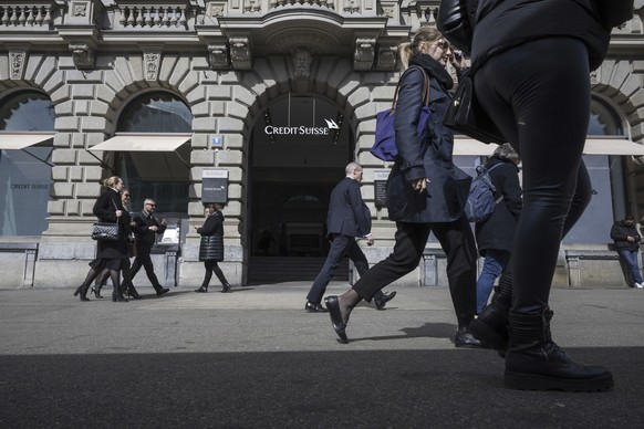 People walk past the entrance of Swiss bank Credit Suisse at their headquarters in Zurich, Switzerland, Thursday March 16, 2023. Credit Suisse&#039;s shares soared 30% on Thursday after it announced i ...