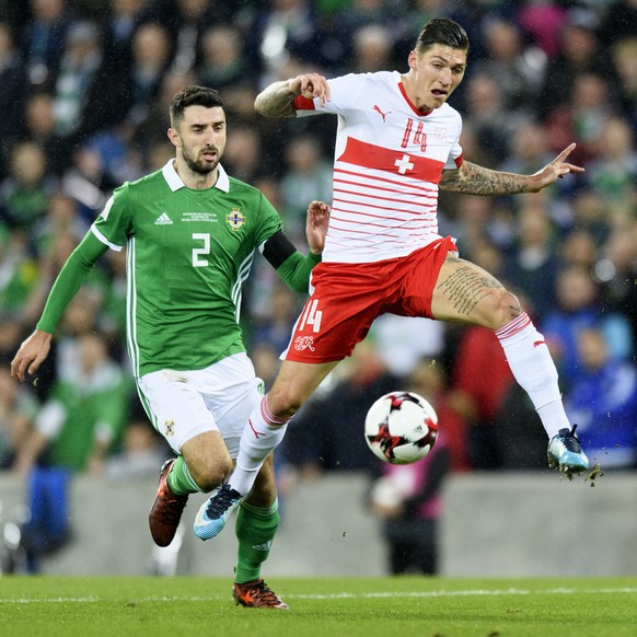 Northern Ireland's defender Conor McLaughlin, left, fights for the ball with Switzerland's midfielder Steven Zuber, right, during the 2018 Fifa World Cup play-offs first leg soccer match Northern Ireland against Switzerland at Windsor Park, in Belfast, Northern Ireland, Britain, Thursday, November 9, 2017. (KEYSTONE/Laurent Gillieron)