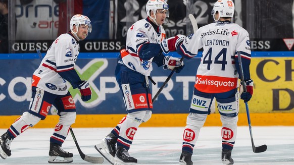 Nicolas Baechler (ZSC), center, celebrate the 2 - 4 goal with Jesper Froeden (ZSC), left and Mikko Lehtonen (ZSC), during Game 2 of the National League play-off match between HC Lugano and ZSC Lions a ...