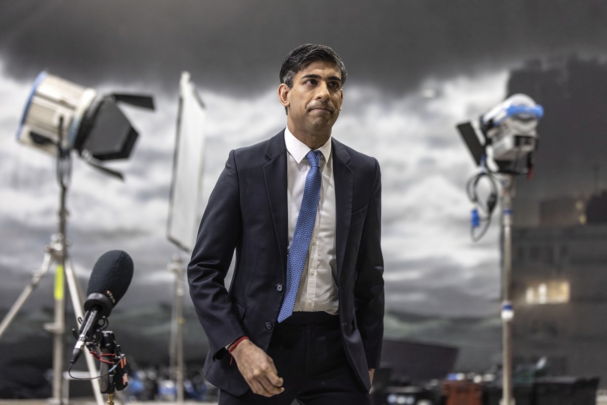 Britain's Prime Minister Rishi Sunak takes part in a TV interview in front of a painted back drop of a stormy sky which was created by students in a film studio at the National Film and Televisio ...