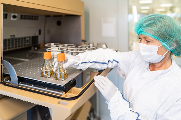 epa08892064 A handout picture made available by Novavax CZ shows a worker at the Novavax CZ production plant near Prague, in Bohumile, Czech Republic, 12 August 2020 (issued 18 December 2020). The EU  ...