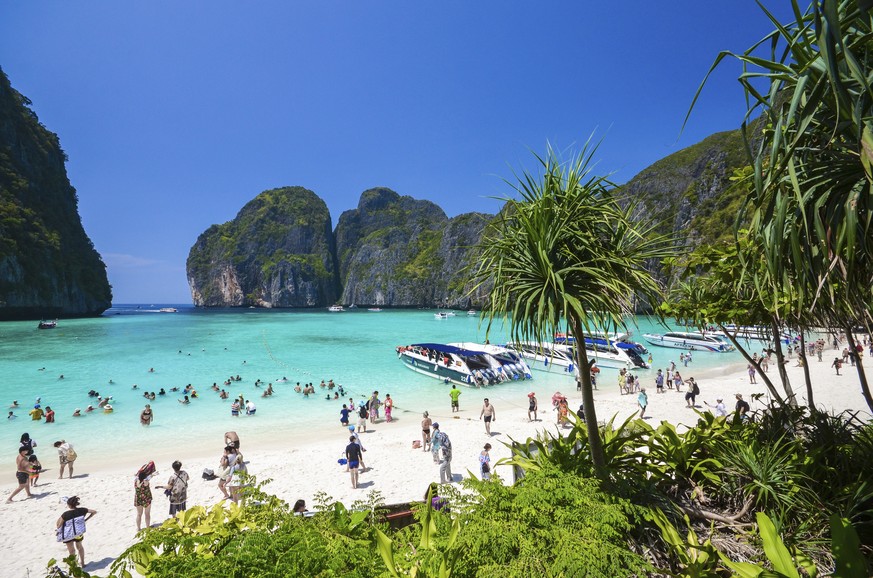 In this March 4, 2017, photo, tourists enjoy the popular Maya bay on Phi Phi island, Krabi province. Authorities have ordered the temporary closing of the beach made famous by the Leonardo DiCaprio mo ...