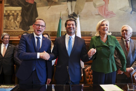 epa10992836 The leader of Portuguese far-right party Chega, Andre Ventura (C), greets the leader of the French parliamentary group from Rassemblement National, Marine Le Pen (2-R), and the German poli ...