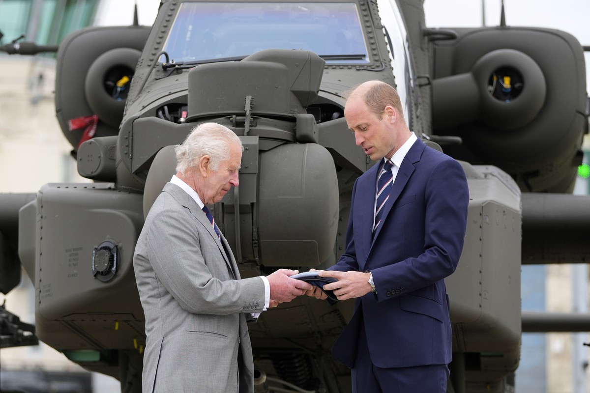 Britain's King Charles III officially hands over the role of Colonel-in-Chief of the Army Air Corps to Prince William, The Prince of Wales in front of an Apache helicopter at the Army Aviation Ce ...