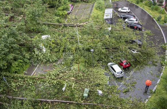 Fallen trees and broken branches have buried and heavily damaged cars after the severe thunderstorm on the Kaeferberg in Zurich, Tuesday, July 13, 2021. Violent thunderstorms with heavy rain, hailstor ...