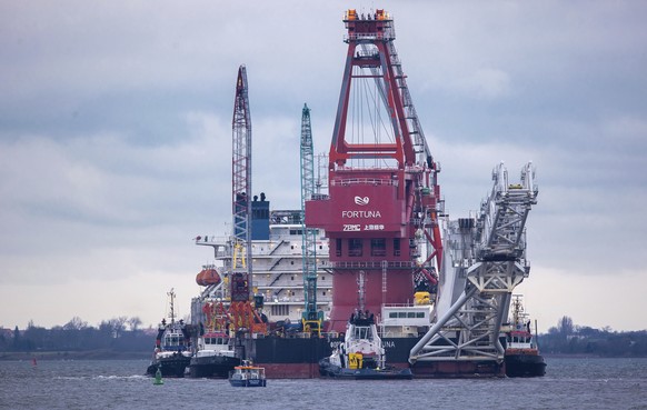 FILE - In this Jan. 14, 2021, file photo, tugboats get into position on the Russian pipe-laying vessel &quot;Fortuna&quot; in the port of Wismar, Germany. The special vessel is being used for construc ...