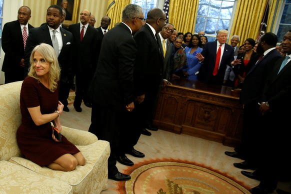 Senior advisor Kellyanne Conway (L) attends as U.S. President Donald Trump (behind desk) welcomes the leaders of dozens of historically black colleges and universities (HBCU) in the Oval Office at the ...