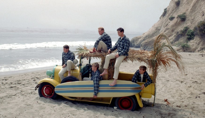 LOS ANGELES - AUGUST 1962: Rock and roll band &quot;The Beach Boys&quot; pose for a portrait with a vintage station wagon in August 1962 in Los Angeles, California. (L-R) Carl Wilson, Mike Love, Denni ...