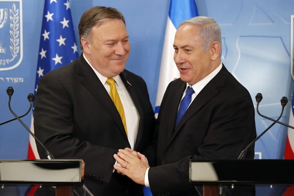 U.S. Secretary of State Mike Pompeo. left. is greeted by Israeli Prime Minister Benjamin Netanyahu ahead of a press conference at the Ministry of Defense in Tel Aviv, Sunday, April 29, 2018. (Thomas C ...