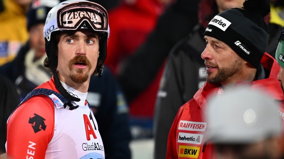epa10427366 Marc Rochat (L) of Switzerland reacts in the finish area during the second run of the Men&#039;s Slalom Night race of the FIS Alpine Skiing World Cup in Schladming, Austria, 24 January 202 ...