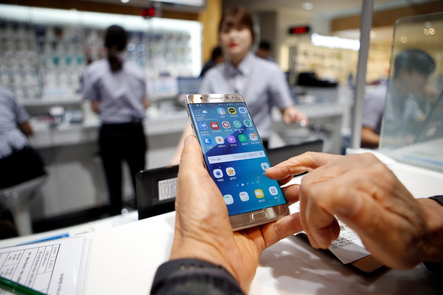 FILE PHOTO - A customer uses his Samsung Electronics&#039; Galaxy Note 7 as he waits for an exchange at company&#039;s headquarters in Seoul, South Korea, October 13, 2016. REUTERS/Kim Hong-Ji/File Ph ...