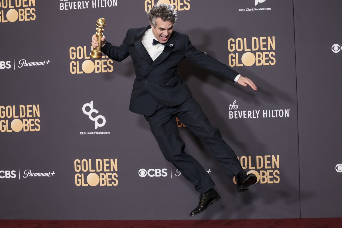epa11063679 US actor Mark Ruffalo jumps while holding a Golden Globe award for the movie 'Poor Things' in the press room during the 81st annual Golden Globe Awards ceremony at the Beverly Hi ...