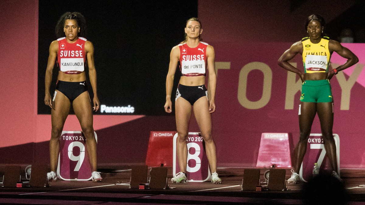 Mujinga Kambundji of Switzerland, left, Ajla Del Ponte of Switzerland, center, and Shericka Jackson of Jamaica, right, line up at the start of the women's 100 m final at the 2020 Tokyo Summer Oly ...