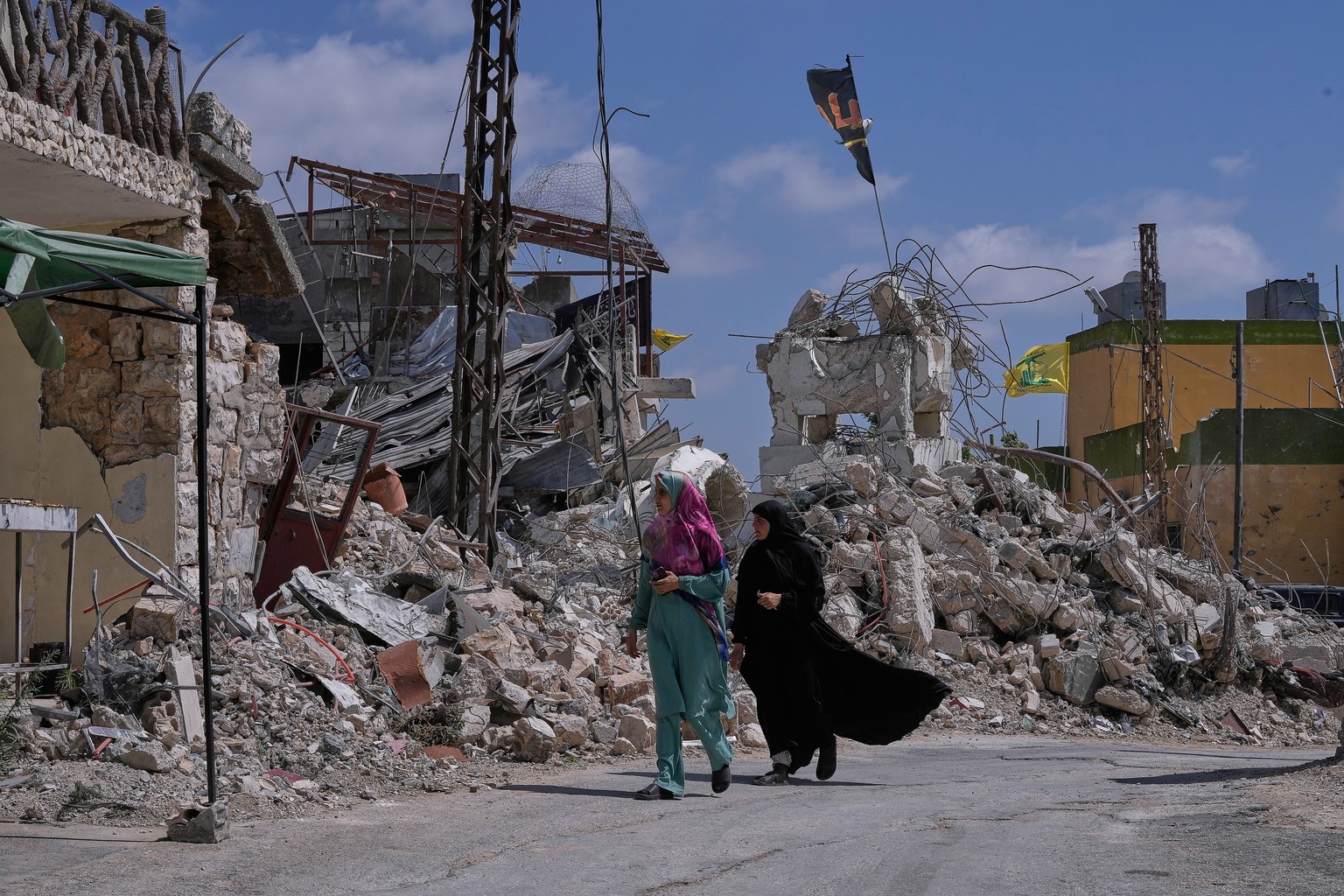 Lebanese women pass by houses that were destroyed in Israeli strikes during the war with Hezbollah in Froun village, southern Lebanon, Thursday, July 16, 2026. (AP Photo/Mohammed Zaatari)
Lebanon Isra ...