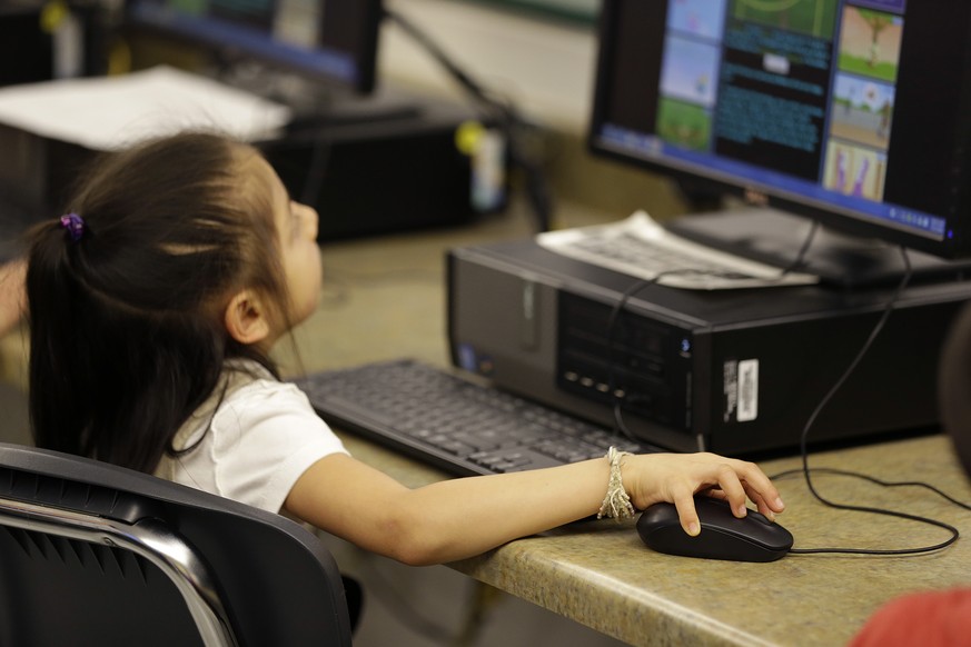 In this Thursday, March 12, 2015 photo, a first-grader learns keyboarding skills at Bayview Elementary School in San Pablo, Calif. Schools around the country are teaching students as young as 6 years  ...