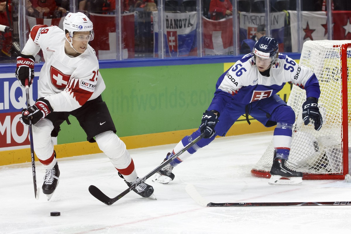 Switzerland's forward Reto Schaeppi, left, vies for the puck with Slovakia's defender Michal Cajkovsky, right, during the IIHF 2018 World Championship preliminary round game between Slovakia ...