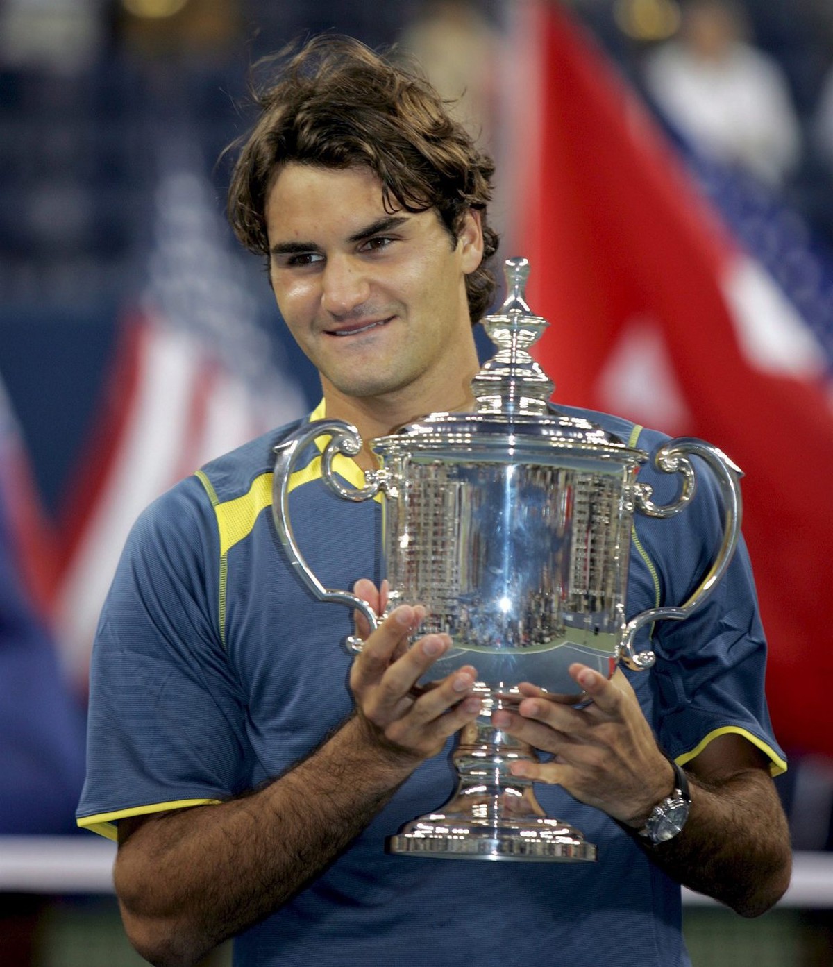 Roger Federer of Switzerland holds up the Championship Trophy after defeating Andre Agassi of the US in the men's final at the 2005 US Open Tennis Tournament at the US Tennis Center in Flushing M ...