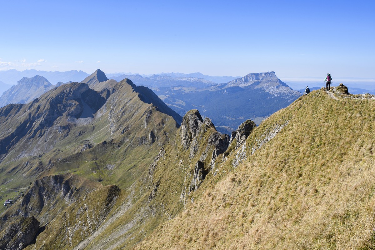 Two women walk on the Brienzer Rothorn Mountain, 2350 meters above sea level, in the Bernese Alps on the boundary between the Cantons of Berne and Lucerne, Switzerland, on Wednesday, October 10, 2018. ...